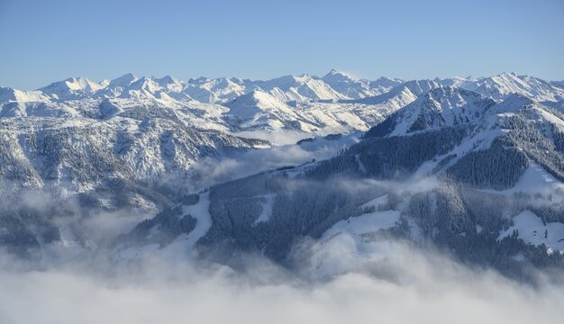 View over Brixental, mountain panorama in winter, cloud cover in the valley, SkiWelt Wilder Kaiser Brixental ski area, Brixen im Thale, Tyrol, Austria