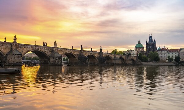 Karlův most, Charles Bridge at dawn, dome of the Church of the Holy Cross, Charles Bridge with Old Town Bridge Tower, Prague, Bohemia, Czech Republic