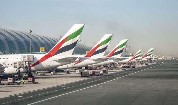 Aircraft tail units of several Airbus A380 of the airline Emirates, aircraft lined up at the terminal, Dubai Airport, Dubai, United Arab Emirates