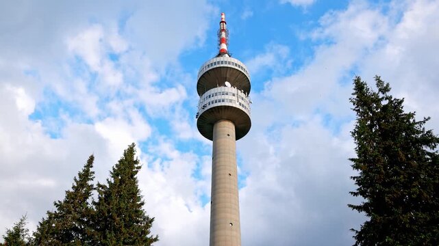 Tower Snezhana on peak of Snezhana covered with spruce forests in Rhodope mountains