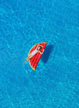 Child in swimming pool. Having fun on vacation at the hotel pool. Colorful vacation concept.