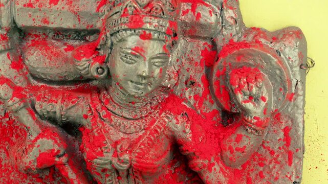 Cinematic close-up of Devi idol with sindoor highlighted under low light, creating a powerful and intense spiritual visual.