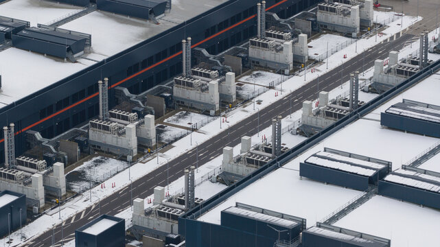 Aerial view of Agriport A7 datacenter featuring industrial cooling units and snow-covered infrastructure in Middenmeer, Noord-Holland, Netherlands.