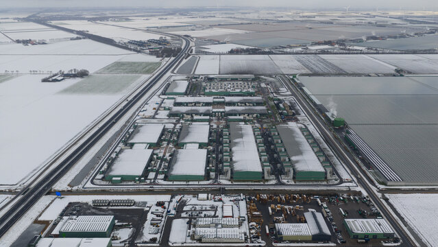 Aerial view of the Agriport A7 datacenter complex surrounded by snow-covered fields and industrial greenhouses in Middenmeer, Noord-Holland, Netherlands.