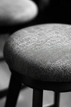 A pair of antique stools with intricate carvings in a classic black and white photograph