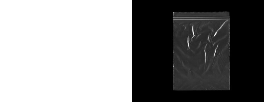 Transparent plastic ziplock bag empty on gray and black backgrounds.