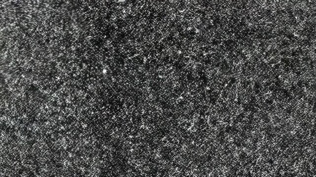 Abstract, textured black and white surface with a pattern of interwoven threads and specks