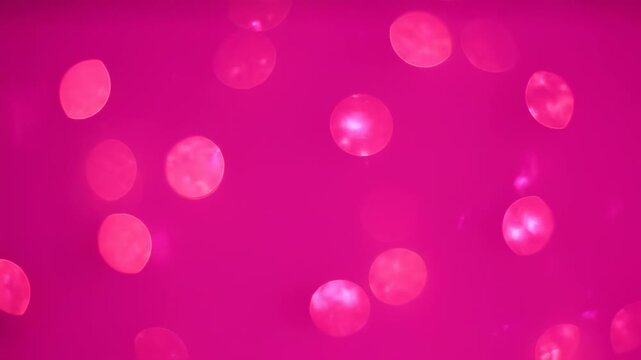 Pink abstract background with blurred, glowing orbs