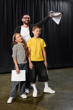 Stylish male tutor inspires kids in playful theater expression and creativity session