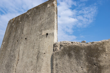 Weathered Concrete Wall Against Blue Sky © magann