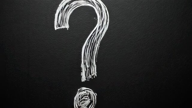 A white, chalk-like question mark on a textured black surface. Simple and minimalist design