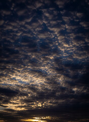 Obraz premium Dark clouds with little bits of sunlight peeking through.