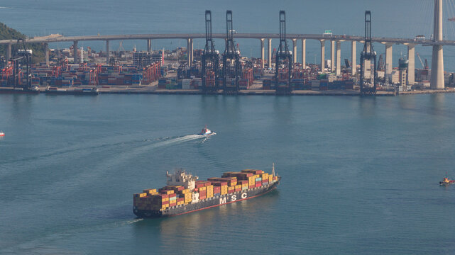Hong Kong, Hong Kong - 15 February 2026: Aerial view of Kwai Chung Container Terminal II with a large MSC container ship navigating the harbor near Stonecutters Bridge.