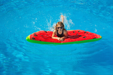 Child in swimming pool. Having fun on vacation at the hotel pool. Colorful vacation concept.