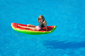 Child in swimming pool. Having fun on vacation at the hotel pool. Colorful vacation concept.