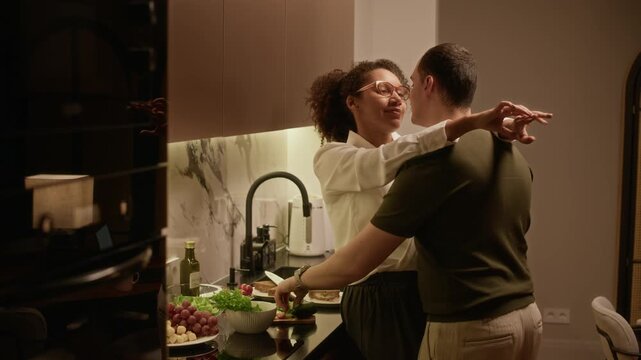 Man looking at woman, hugging her while she talking to him and smiling widely