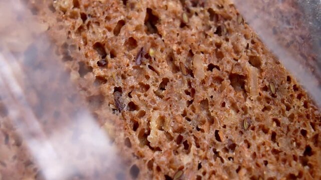 Whole grain rye German bread in an open plastic package. Rotation