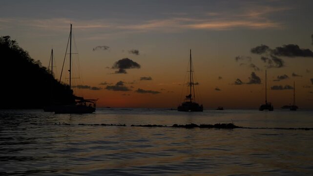 Marigot Bay St Lucia Sunset Time-lapse: Luxury Yachts and Sailboats Dancing on Calm Water during Golden Hour