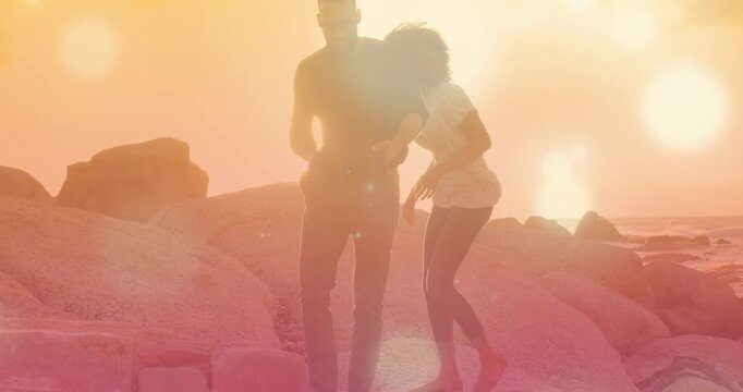 Animation of light spots over couple at beach