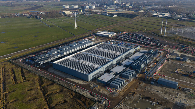 Groningen, Netherlands - 20 January 2026: Aerial view of Datacenter Westpoort with its large industrial structure, cooling systems, and surrounding green fields.