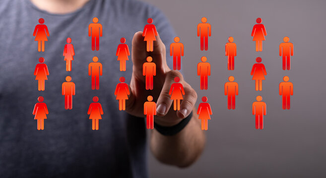 A person's hand interacting with virtual human icons, representing connection, community, and diversity in a digital wo