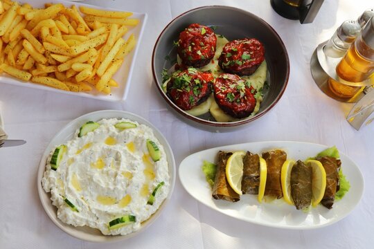 Albanian cuisine meze. Restaurant meal with qofte meatballs, salce kosi strained yoghurt and japrak stuffed grape leaves.