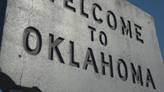 Close up of Gray Concrete Engraved Welcome to Oklahoma Sign at State Border 