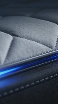 Vertical video: Lighting LED strip drawing view across quilted panel seam in studio showing stitch