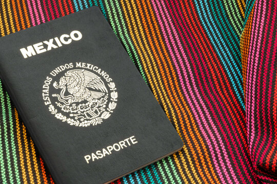 Mexican passport lying on a colorful sarape textile