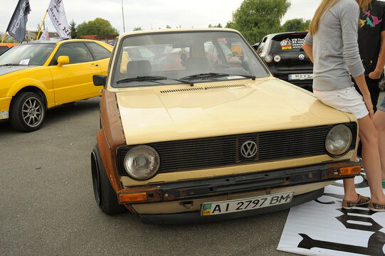 Custom 1974-1983 Volkswagen Golf Mk1 with rat look rusty wing at an outdoor car festival