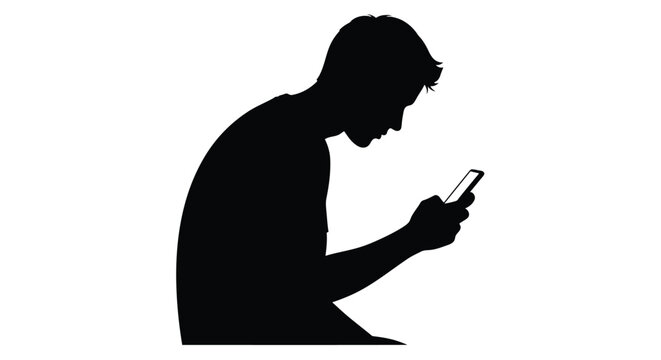 Silhouette of a young man looking at his smartphone