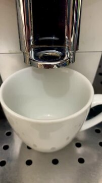Black Coffee Pouring into Cup from Coffee Machine Close Up