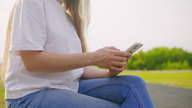 Woman chatting online on smartphone macro close up, typing text message, touching touchscreen keyboard, using messenger application. Female holding mobile phone, close up, swiping social media. 