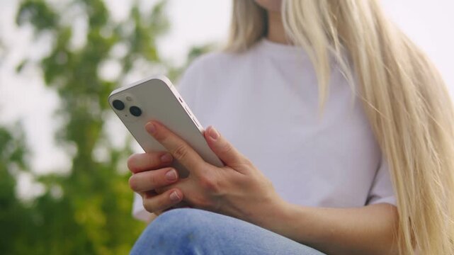 Woman chatting online on smartphone macro close up, typing text message, touching touchscreen keyboard, using messenger application. Female holding mobile phone, close up, swiping social media. 