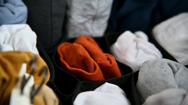 Colorful socks organized in storage container, showcasing neat arrangement and variety