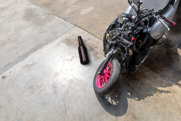 Motorcycle accident crash with alcohol bottle concept drink driving road safety risk