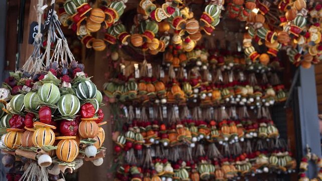 Hanging dried fruit garlands at Easter market stall colorful handmade decorations rustic natural ornaments festive spring craft display close view