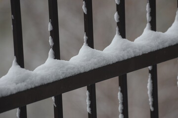 fluffy fresh white snow piles iron railing, uprights (macro, close-up, seasonal) © Don Hoskins