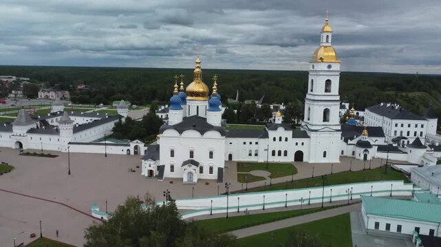 A breathtaking aerial drone view of Tobolsk Kremlin, a unique architectural landmark of Siberia, Russia. The shot captures the majestic white stone walls, cathedrals, and towers 