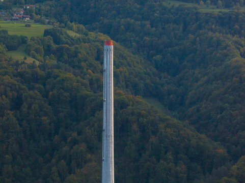 This aerial view shows the tall chimney of an old coal power plant in Trbovlje, Slovenia, now inactive and part of energy transition.