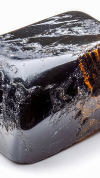 A black rock with a noticeable brown crack