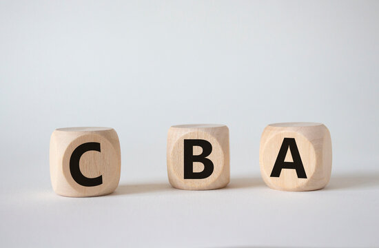 CBA - Cost Benefit Analysis symbol. Wooden cubes with word CBA. Beautiful white background. Business and Cost Benefit Analysis concept. Copy space.