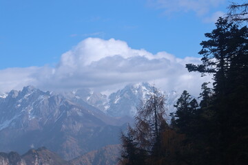 Fototapeta premium Mountains view of Huanglong National Park in autumn through the cable car's window at Songpan County, Sichuan Province of China