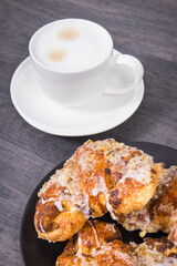 Pastry with poppy seed filing and cup of coffee. Traditional Martin's croissants from polish city Poznan