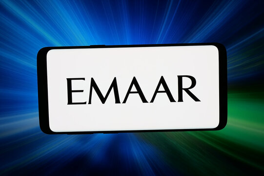 Stuttgart, Germany - 03-19-2026: In this photo illustration, the logo of real estate company Emaar Properties PJSC is displayed on a smartphone in front of abstract background on computer screen.