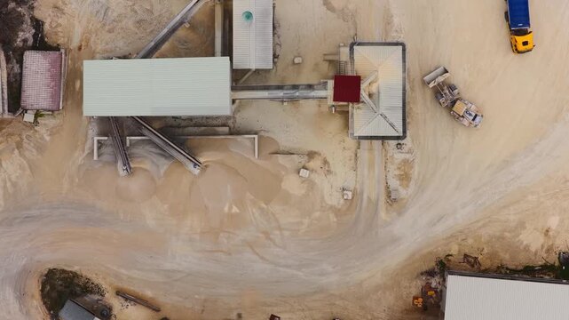 Aerial view of an industrial area with trucks and buildings, showcasing a blend of industrial activity and landscape, Arsoli, Lazio, Italy.