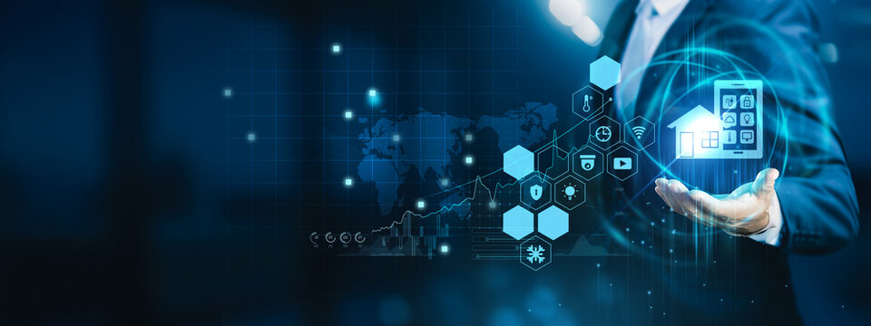 Homeowner holding smart control app. Smart home technology connects devices to automate lighting, security, and energy use.