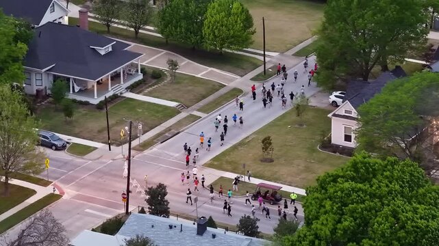 Aerial of Marathon Runners Turning down Street