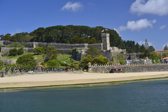 Ribeira Beach and the castle walls on the Way of St James in Baiona.