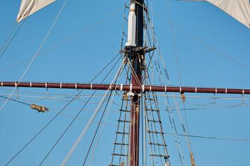Close up of vintage nautical ropes and pulley systems on a tall ship mast with copy space.